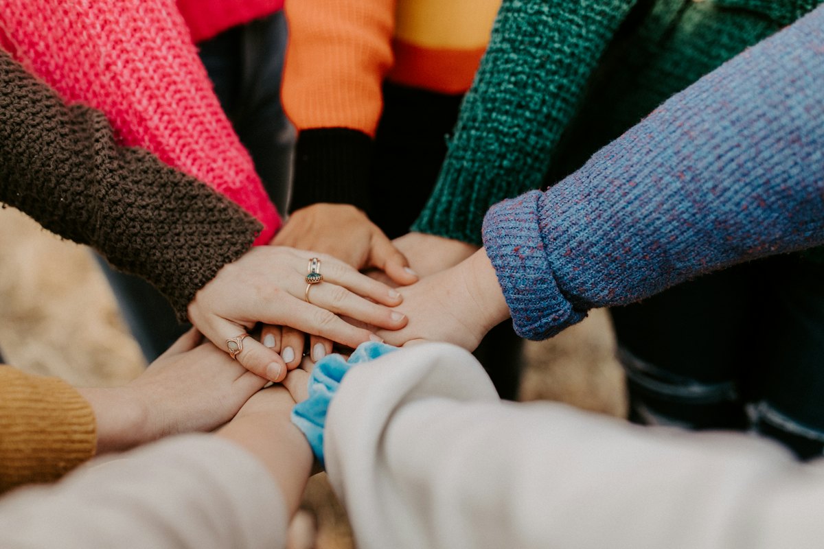 Team members joining hands